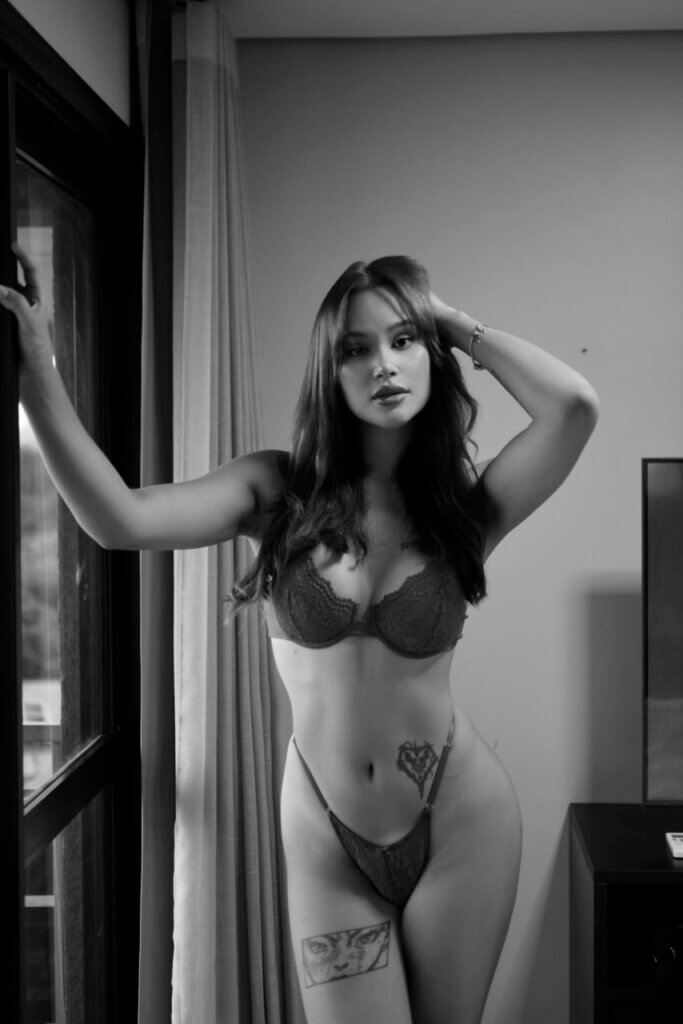 Woman posing in lingerie, black and white